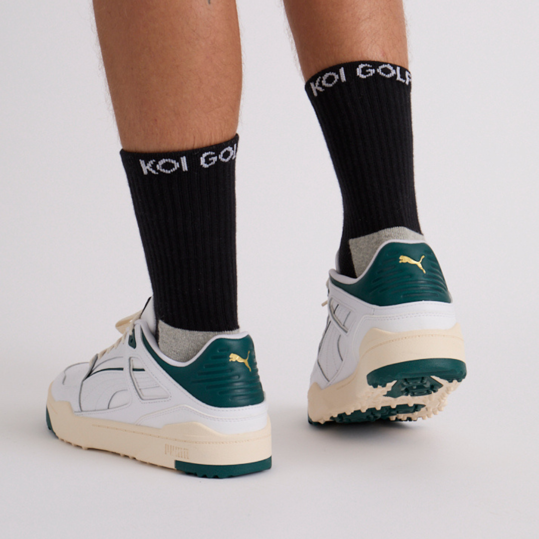 Rear view of black crew mens golf socks in shoe – cushioned heel and sweat-wicking panels