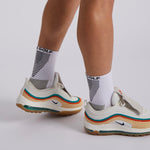 Mens white crew golf socks styled in golf shoe – visible above collar for added support