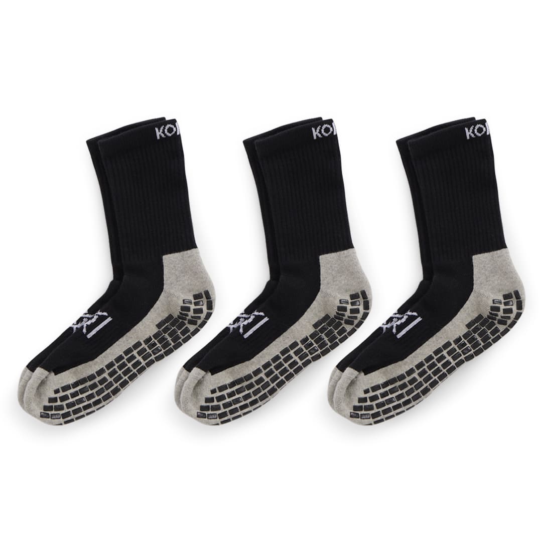 Three pairs of black golf socks with grey soles on a white background