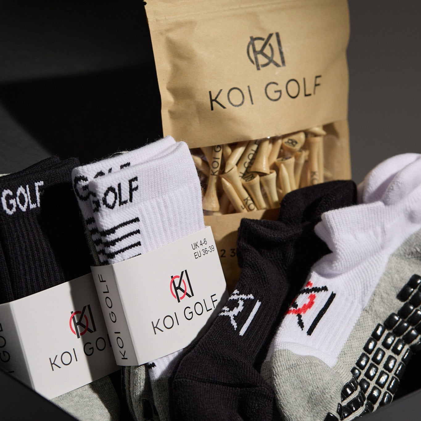 Koi Golf socks and packaging on a dark background