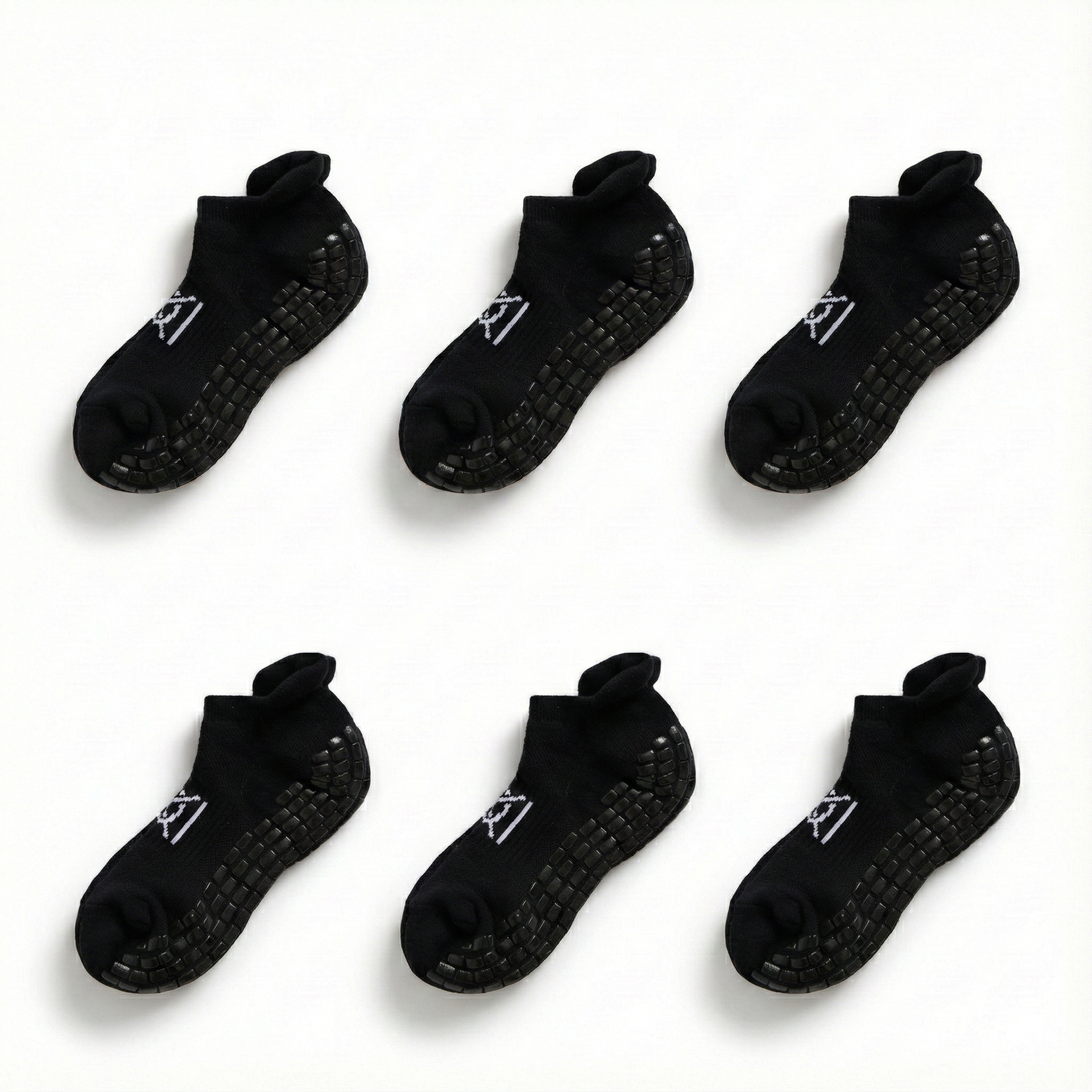 Set of six black socks with textured sole on a white background