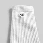 White sock with a black logo on a gray background