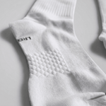 Close-up of a white sock with 'LARGE' text on a light gray background